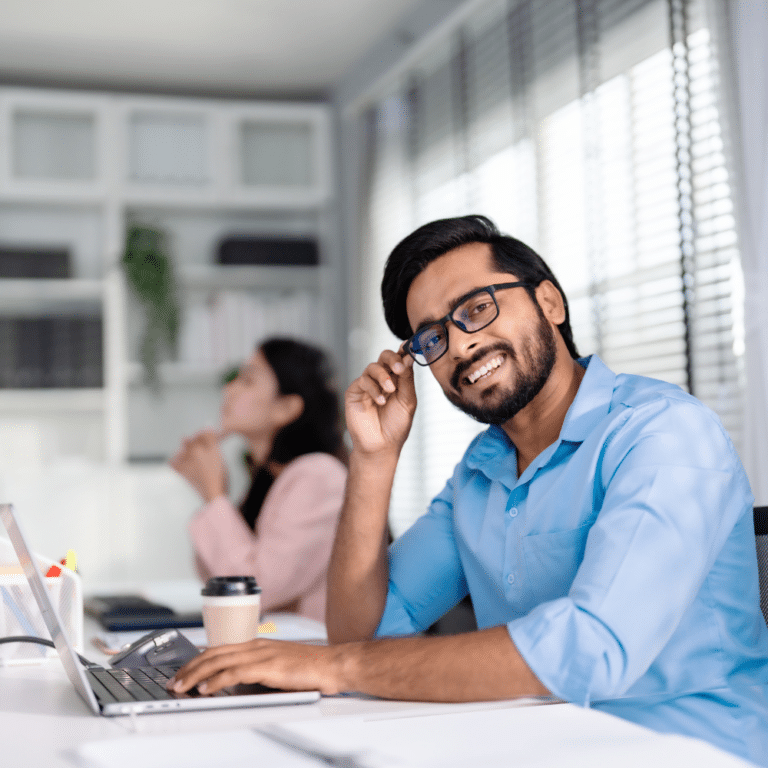 smilling-person-at-laptopn-ap-automation-software-768x768
